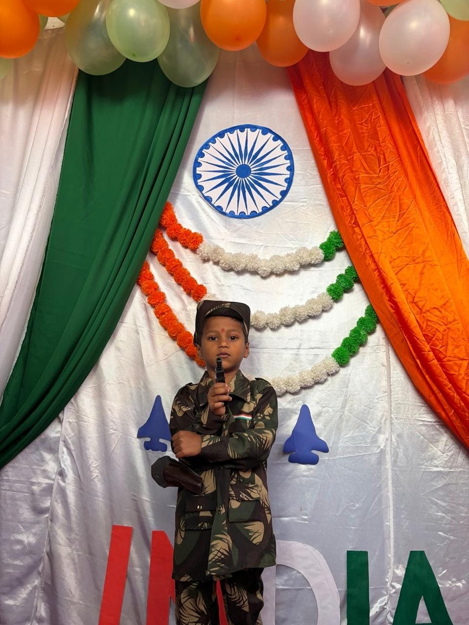 Student in a soldier costume with the Ashoka Chakra backdrop